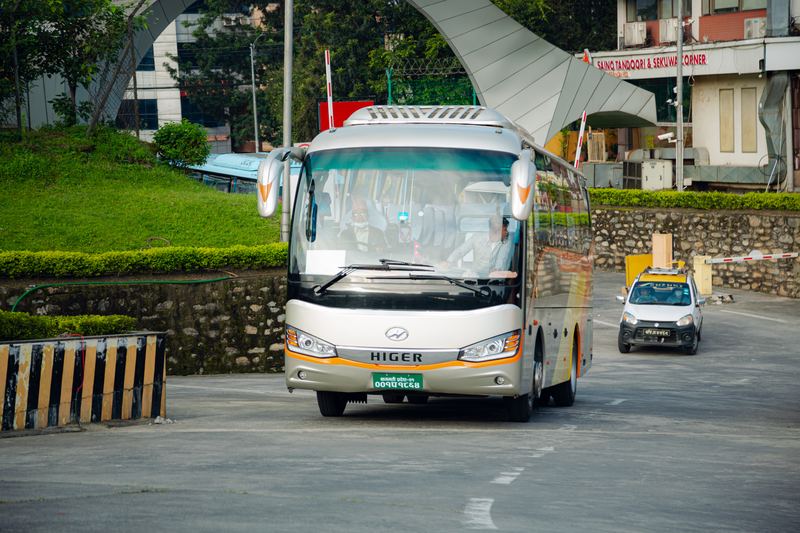 A Higer coach pulling out to collect a group in Kathmandu