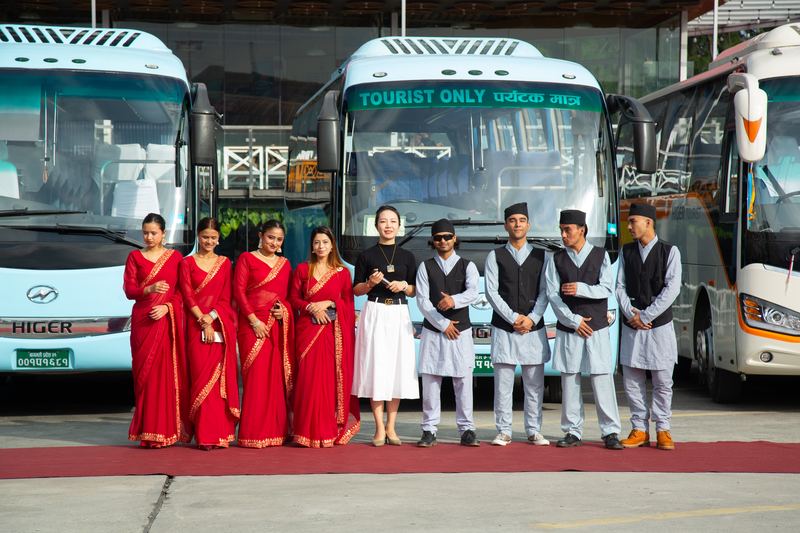 Hosts in red sarees and daura-suruwal waiting on the red carpet