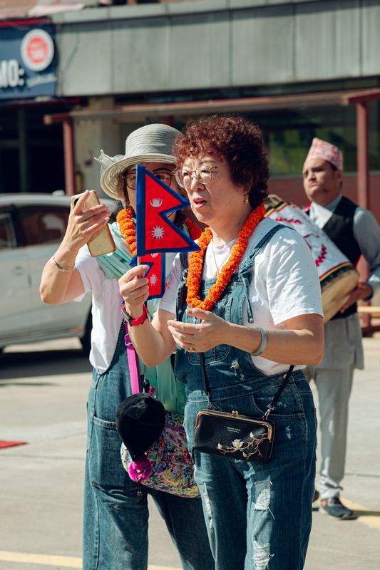 A guest celebrating with the flag of Nepal