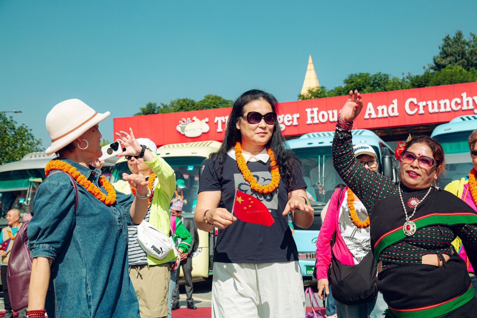 Guests dancing with our hosts, flags of China and Nepal raised